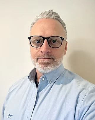 Chris Veness, wearing glasses and a light blue shirt